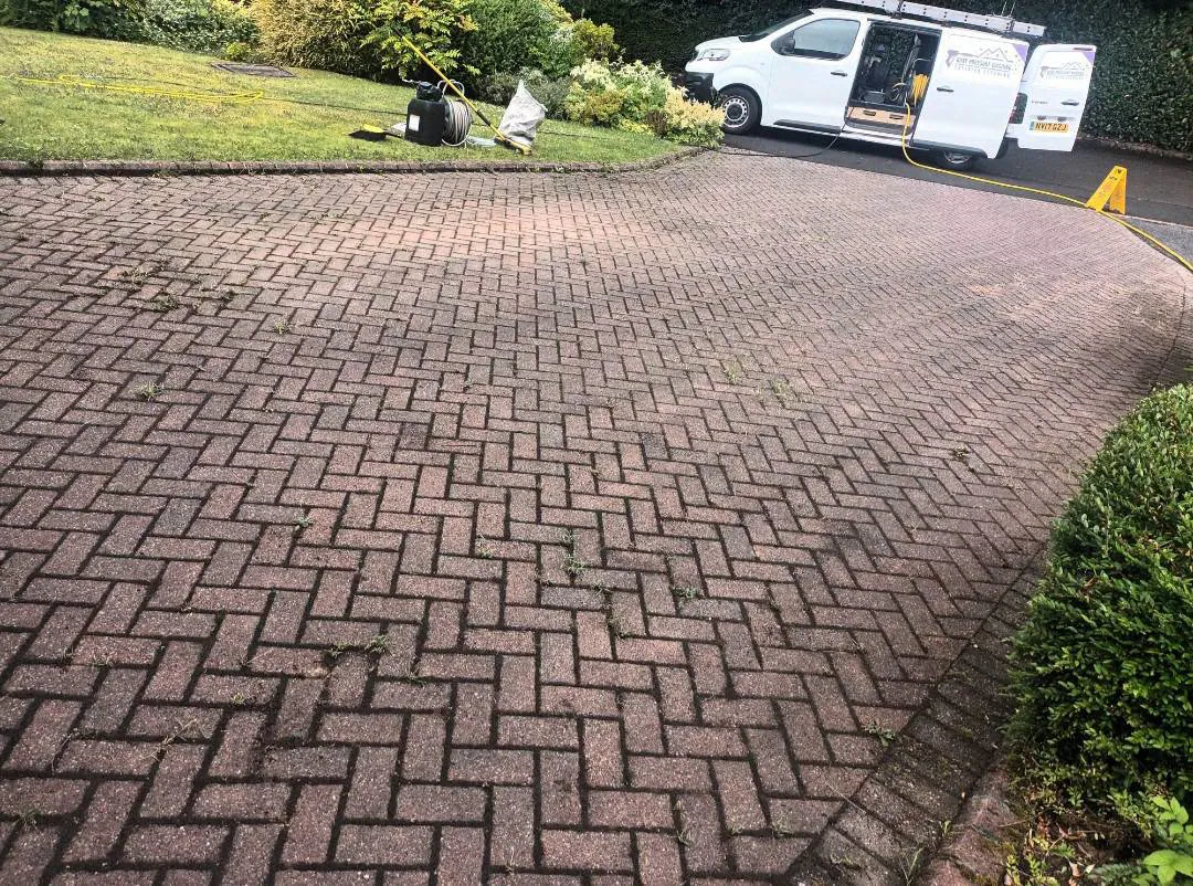 Weathered block-paved driveway before pressure washing