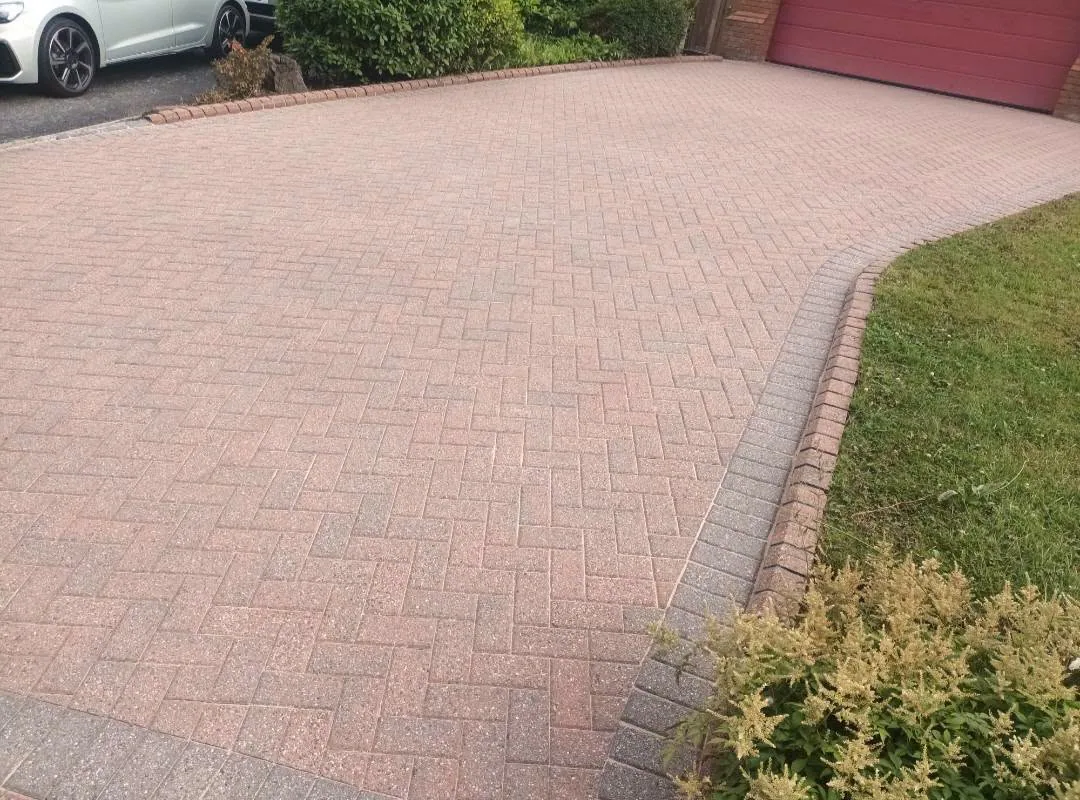 Bright restored driveway after exterior cleaning