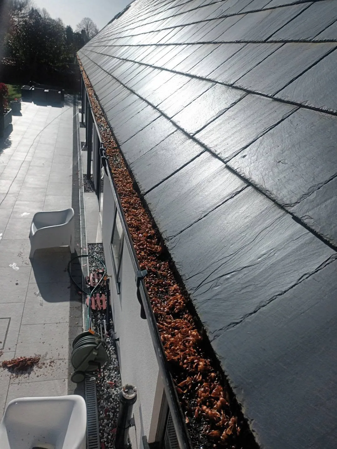 Gutter channel filled with leaves before clearing